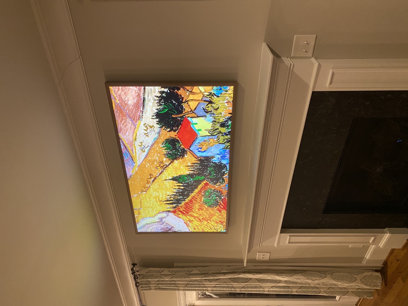 Ensysta Build TV installation displaying artwork above a white fireplace